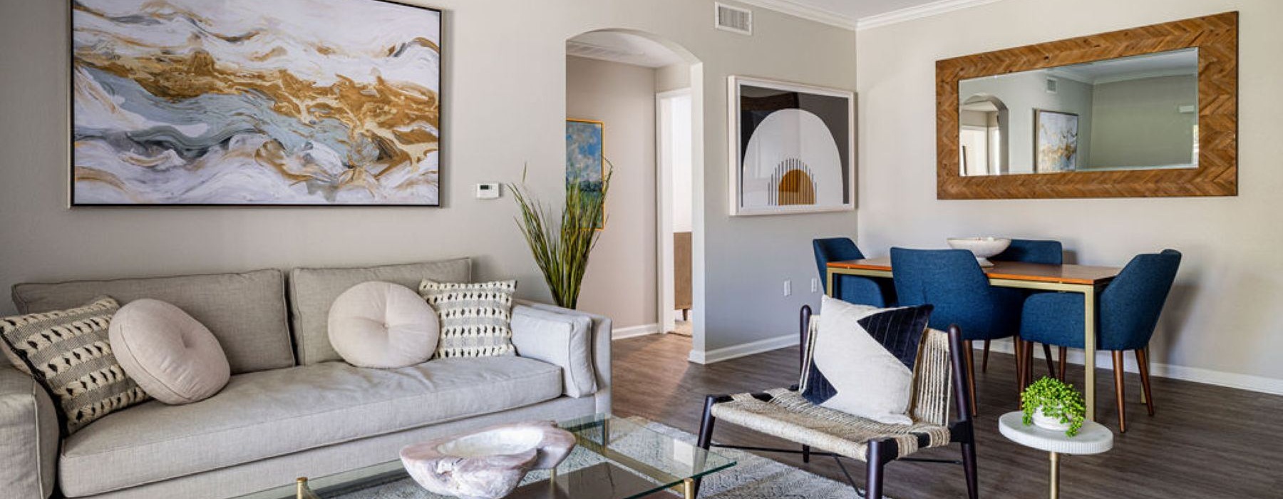 a living room with a large painting and a couch