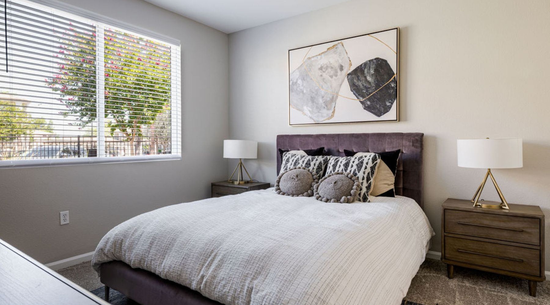 a bedroom with a bed and two nightstands