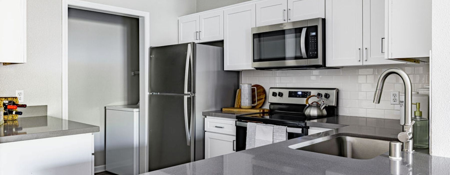 a kitchen with white cabinets