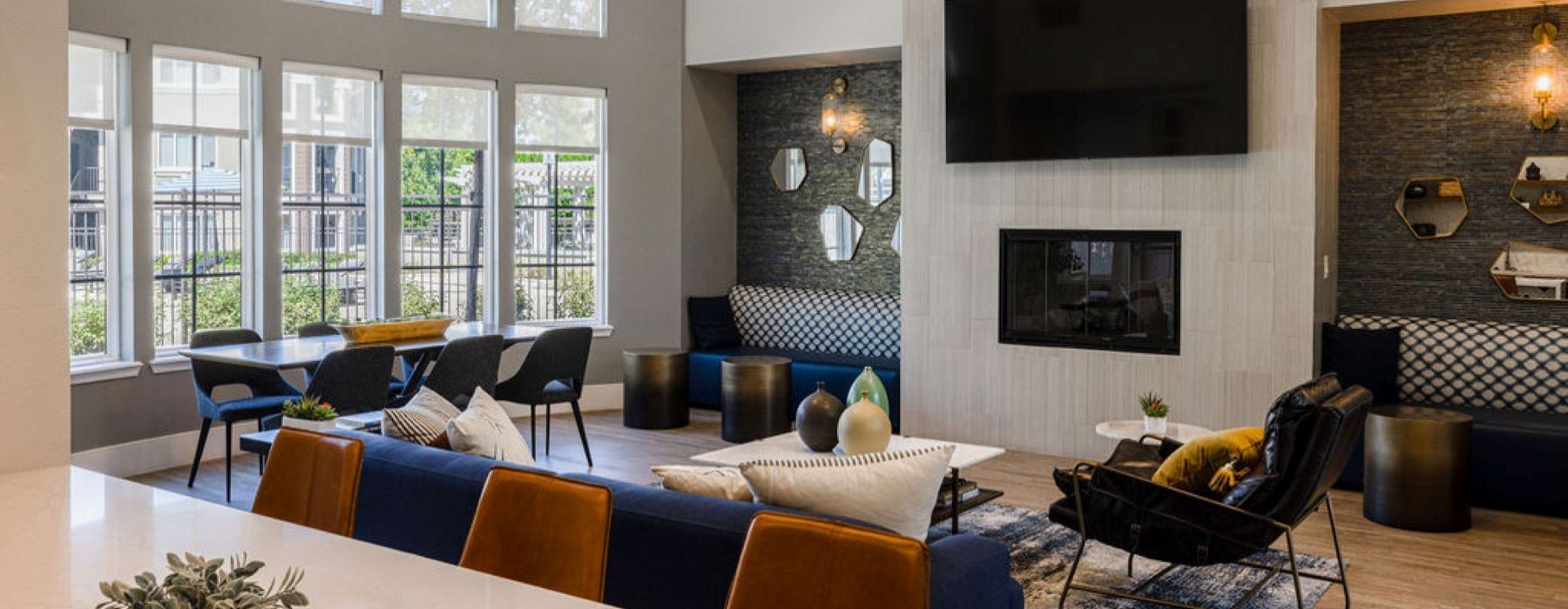 a clubroom with a tv, tables and chairs