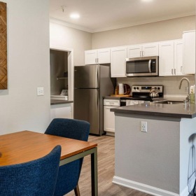 a kitchen with a table and chairs