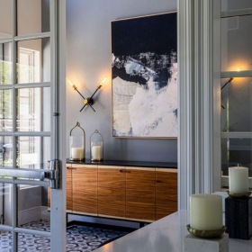 a room with a painting and windows
