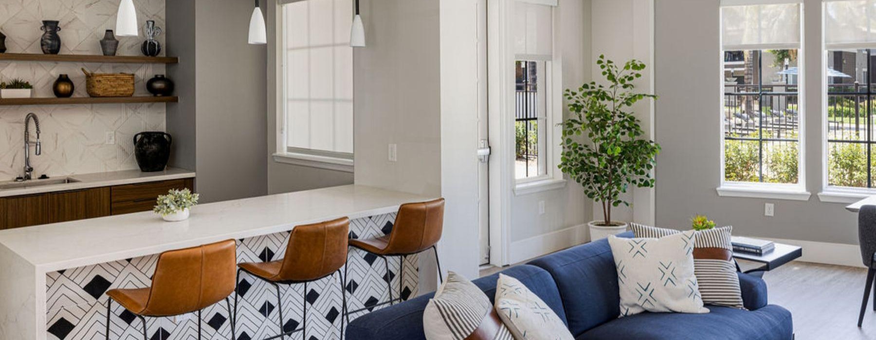 a room with a couch and chairs